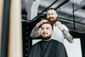 barber-styling-customer-hair-at-barbershop-LS538DX