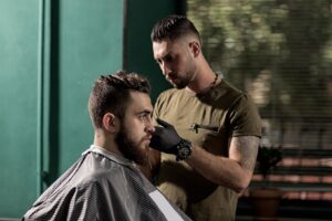 brutal-man-sits-at-a-barber-shop-barber-makes-a-tr-8CSVPZH